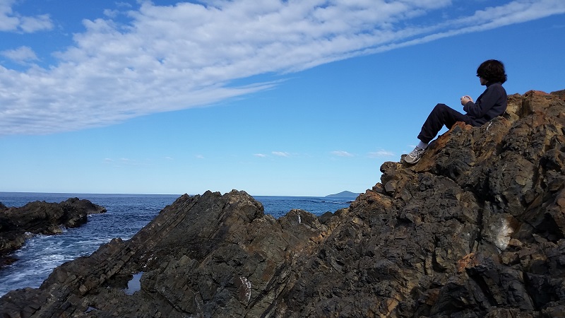 Lone figure on rock
